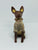 Xolo mini sentado sueter rosa viendo de frente
