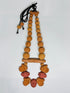 Collar coatlicue manos con tubo atravesado cuentas color natural